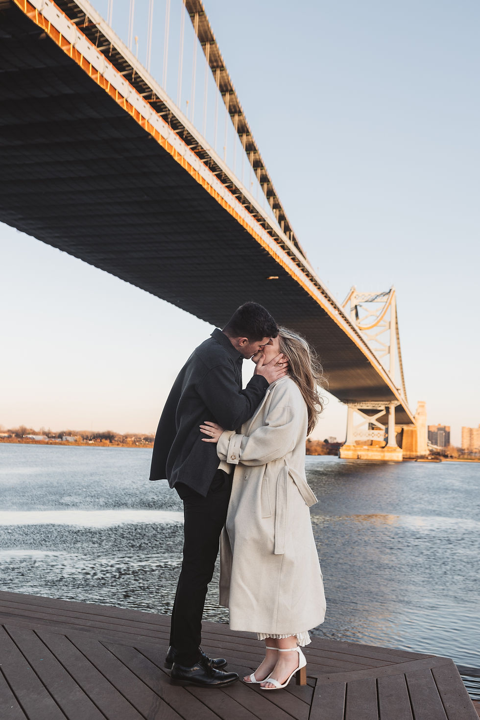 Future bride and groom pose together for their engagement photos at Race Street Pier in Old City, Philadelphia. Taken by Philadelphia wedding photographer Madison Neumann Photography.