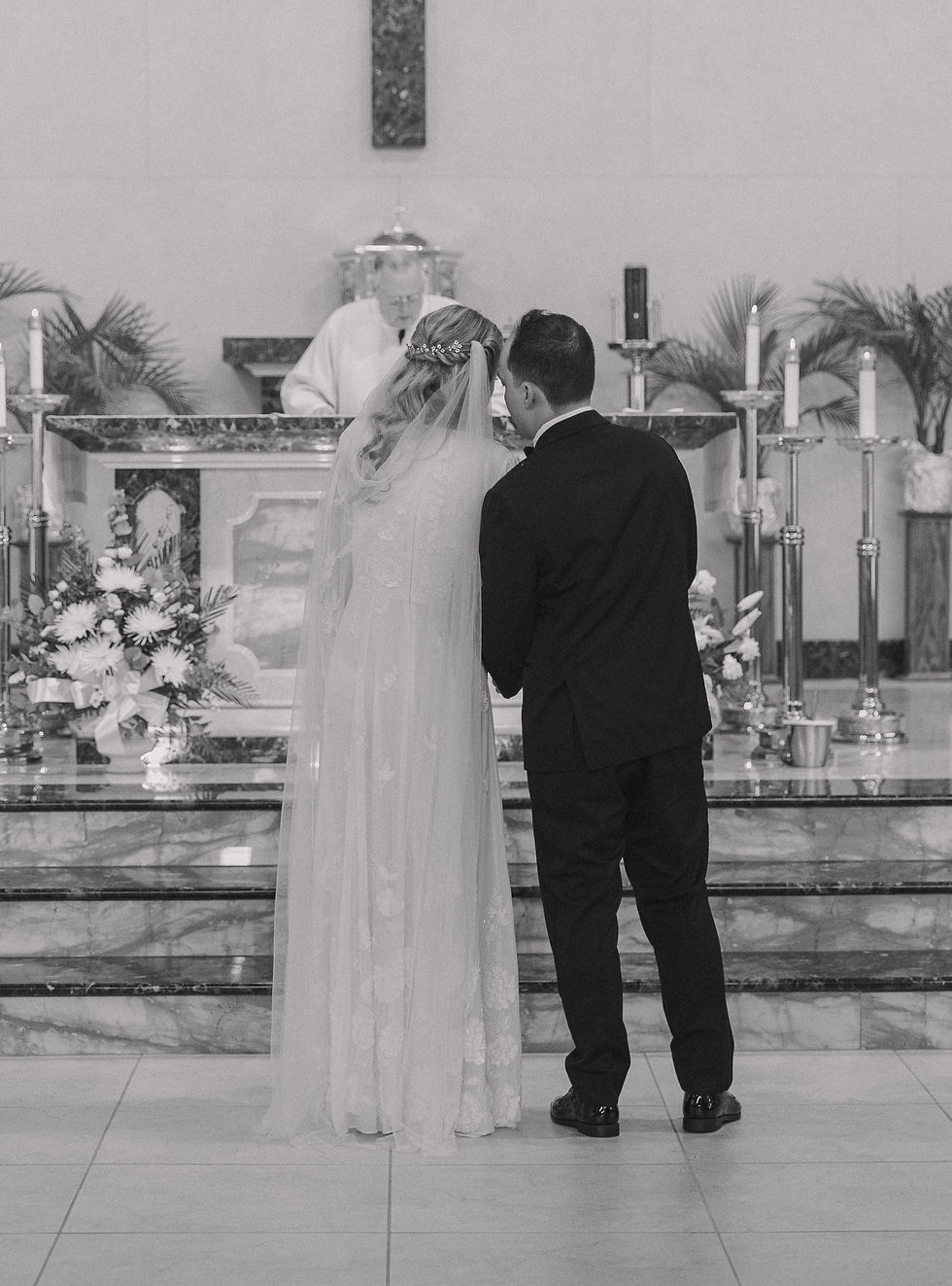 Black and white photograph of bride and groom at the altar for church ceremony in Mantua, New Jersey. Photographed by NJ, PA region wedding photographer Emily Morton Photography.