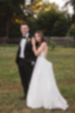 Bride embraces groom for couples portrait for wedding at Bartram's Garden in Philadelphia, PA. Photographed by South Jersey Philly wedding photographer Madison Neumann Photography.