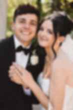 Couples portrait of bride and groom on their wedding day, smiling and holding hands. April wedding day at The Waterfall in Claymont, DE. Photographed by South Jersey, Philly based wedding photographer Madison Neumann Photography.
