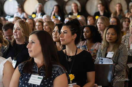 Attendees listening to a presentation at a Women in Finance event.