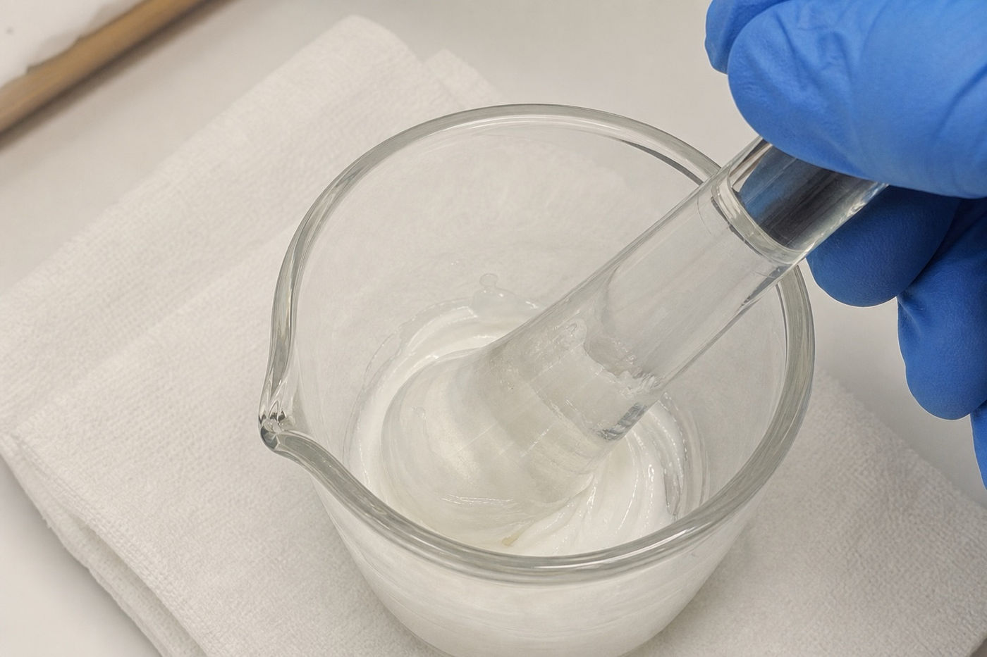 Blending a preparation by hand in a glass mortar at the Murray Shore compounding bench
