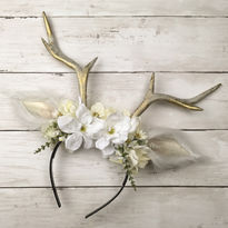 Silver-grey hand-sculpted antlers with furry white ears decorated with white flowers.