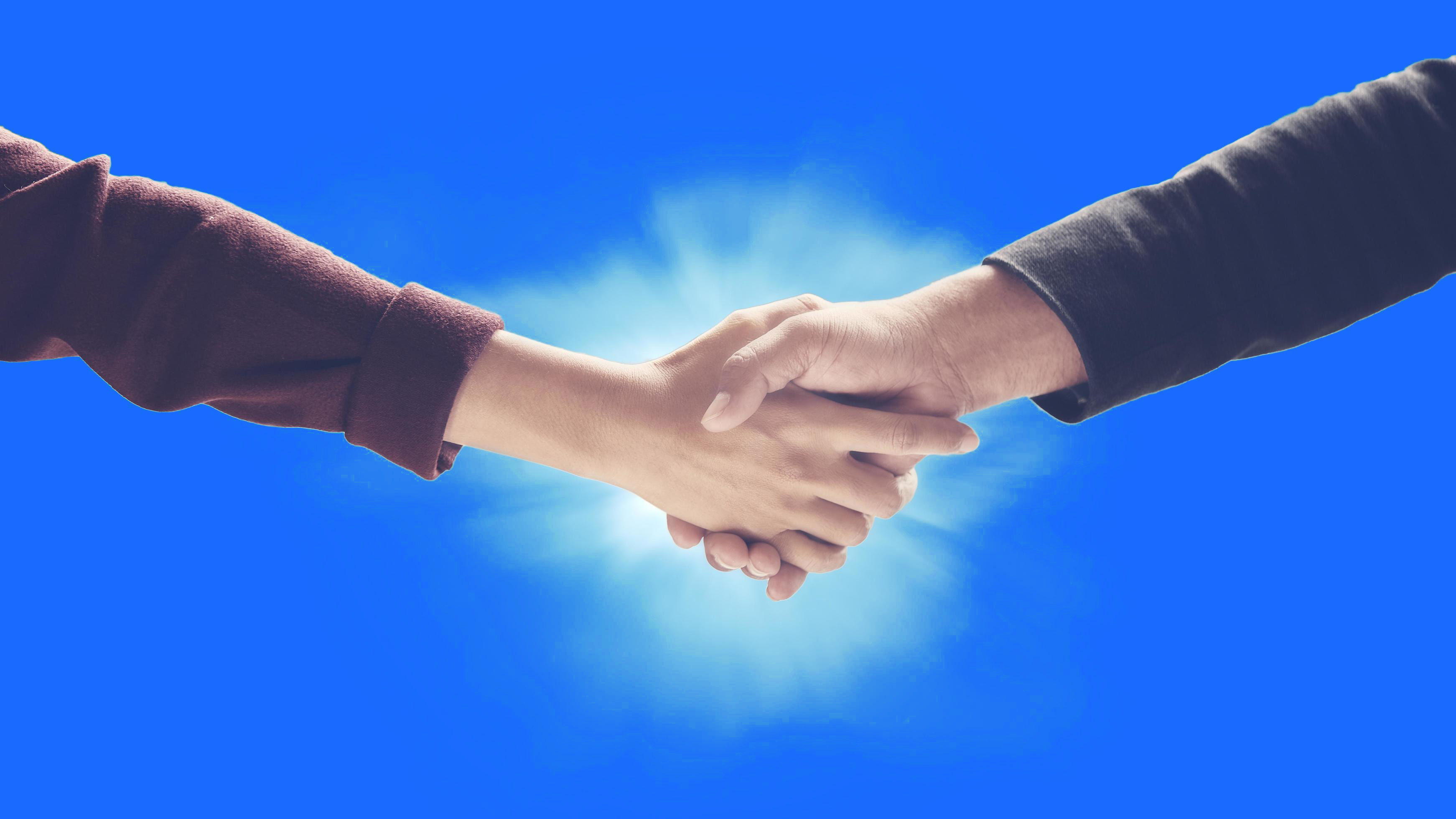 business-handshake-against-blue-background-free-photo.jpg