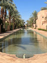 Amanjena luxury resort in Marrakech, Morocco, featuring traditional Moroccan architecture and tranquil reflecting pools.