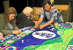Amanda Haran participating in a collaborative textile banner workshop as a contemporary community textile artist