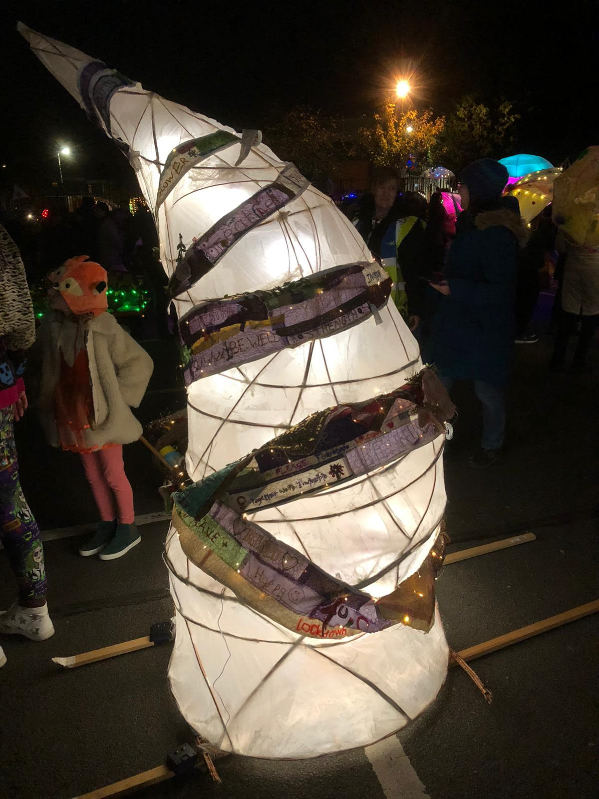 Illuminated collaborative textile lantern made with stitched messages from women in Coventry.