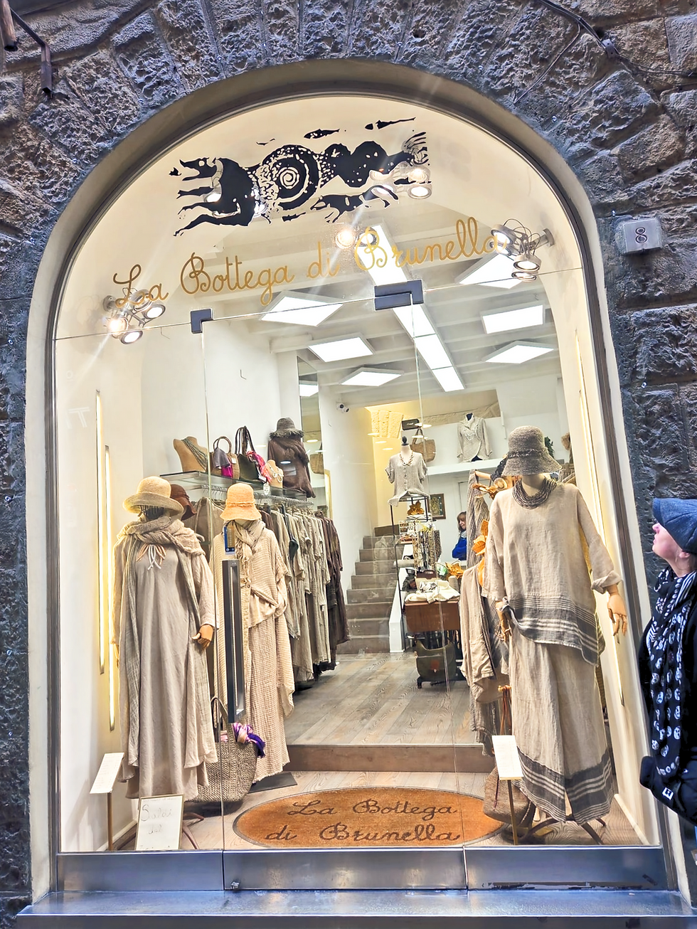Linen clothing displayed in La Bottega di Brunella shop window in Florence showing contemporary garments made from linen textiles