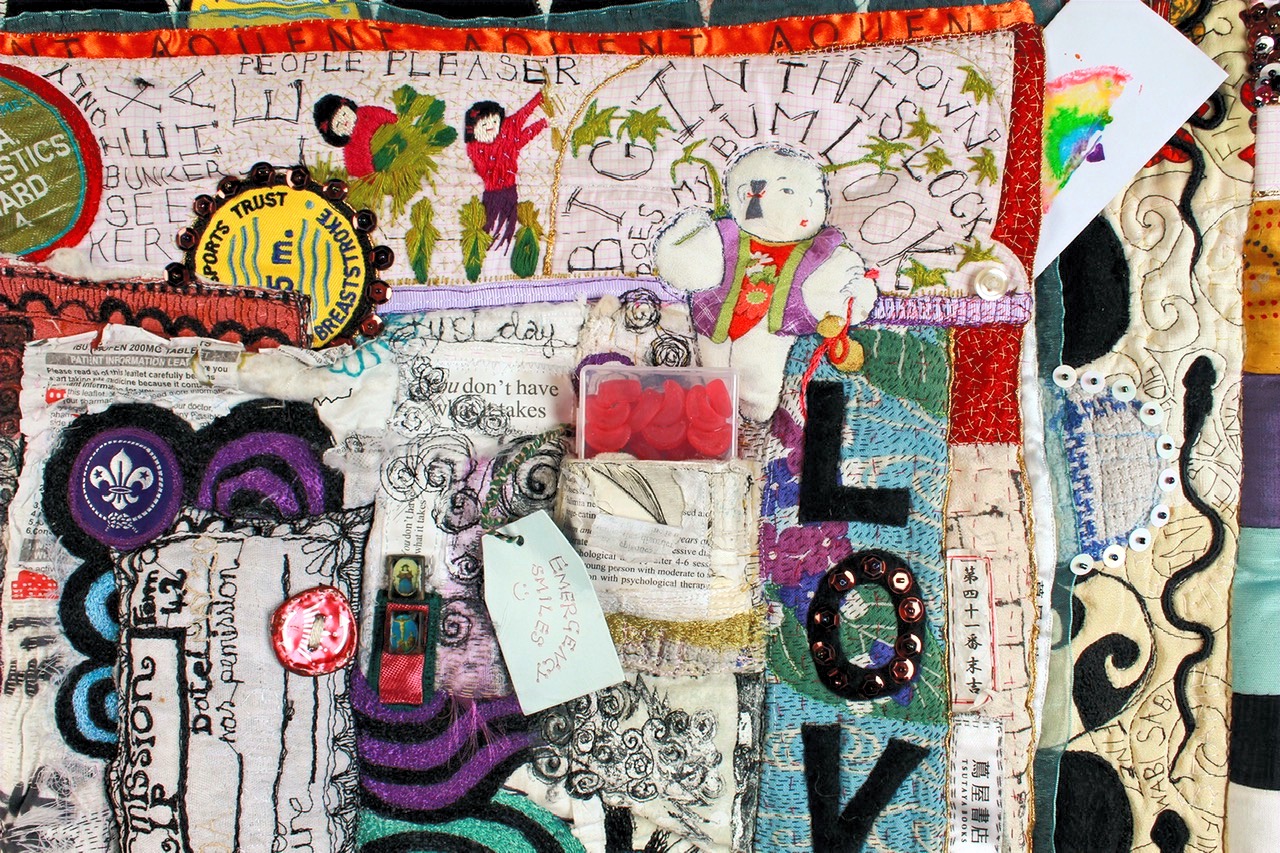 Close detail of stitching and surface work on the Wilderness Quilt.