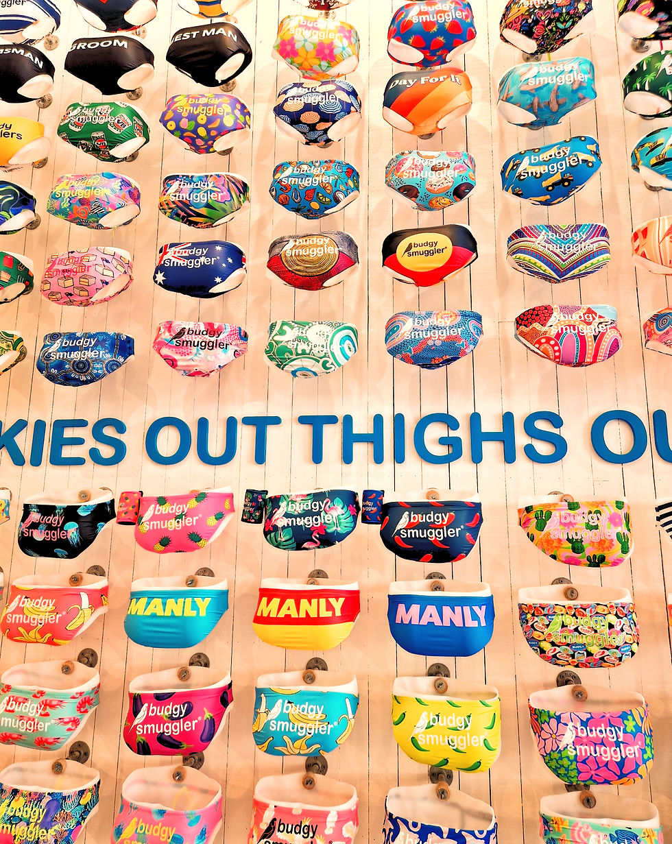 A shelving system in a shop in Manly Australia showing lots of pairs of brightly coloured budgy smugglers