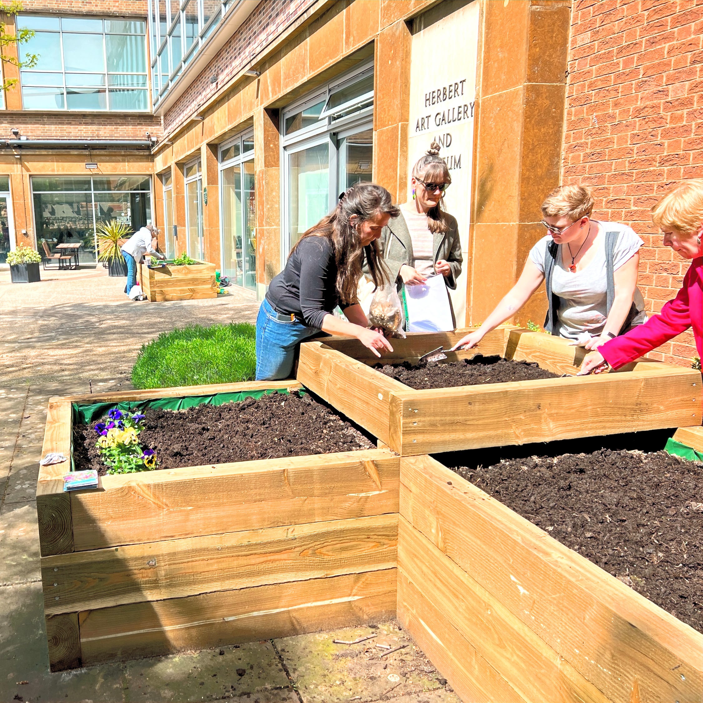 People planting the raised beds in the Herbert’s Community Garden in Coventry.