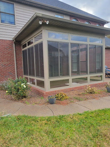 Eye-level view of a spacious custom screen room with wooden framing and mesh screens