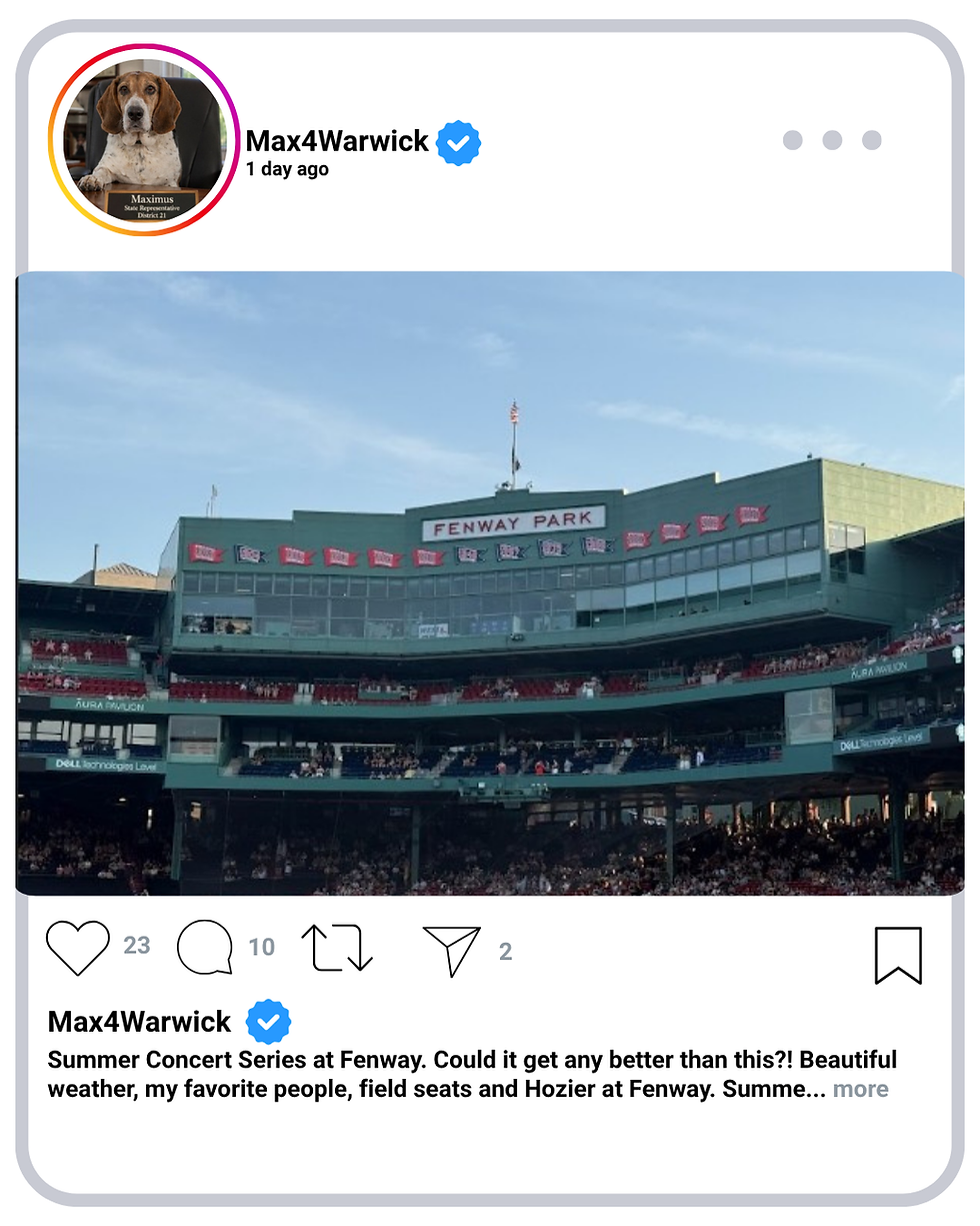 A view of the press boxes and Fenway Park logo behind home plate taken from the outfield on a sunny day. 