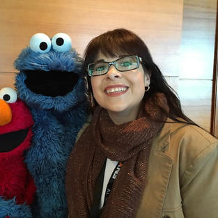 Lori hanging out with Sesame Street's Elmo and Cookie Monster at the PBS Annual Meeting