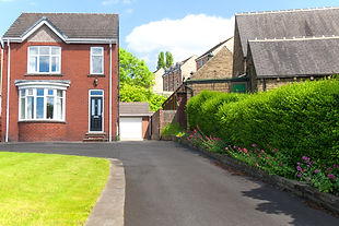 Typical english single family house built of red bricks, with a large driveway