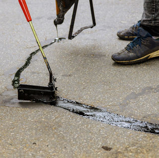 Asphalt road with filled cracks repair, liquid, of the fixed road