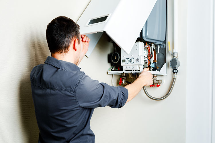 Technician repairing boiler