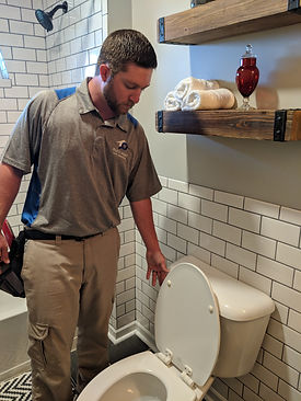 inspecting the bathroom plumbing
