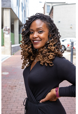 Black woman in a black dress.png