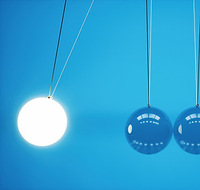 Glowing Newton's cradle ball in motion.