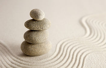 Stacked stones on sand.
