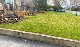 Completed Ottawa Lawn Care lawn and property maintenance with Ottawa Lawn, Parging & Snow sign, showing healthy green yard in