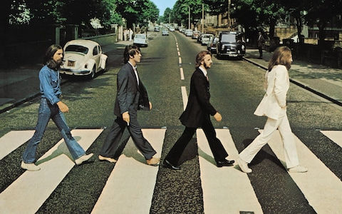 a picture of the beatles walking at abbey road