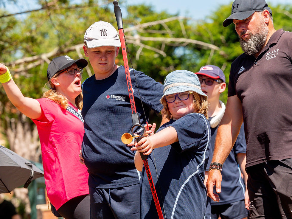 A pupil aiming at a target for Archery during Sports Day