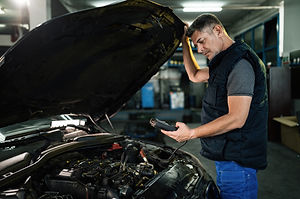 auto-mechanic-using-diagnostic-work-tool-while-checking-car-engine-workshop (1).jpg