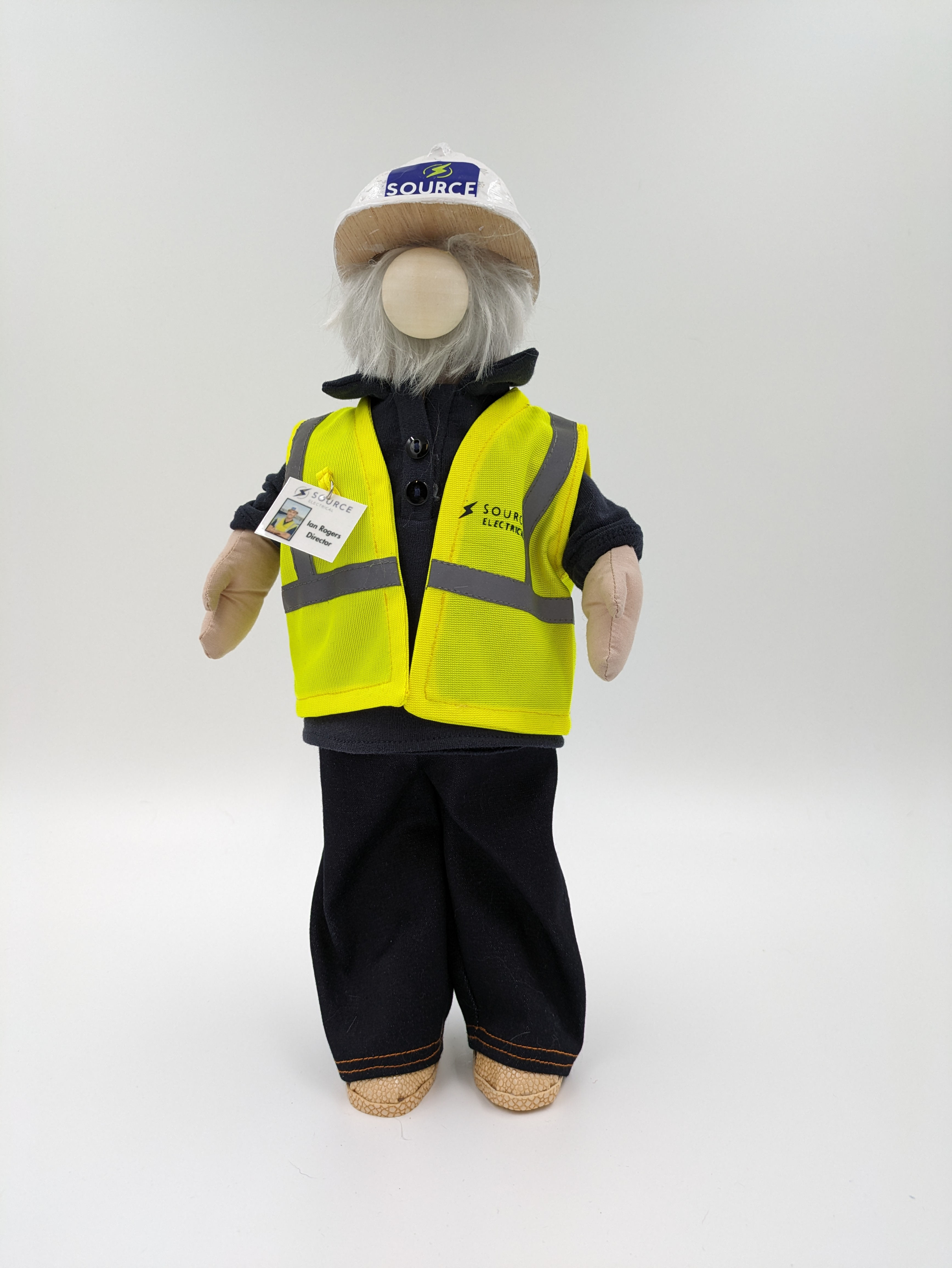 Construction worker wearing, hi-vis jacket, navy polo t-shirt and also wearing a white construction hat