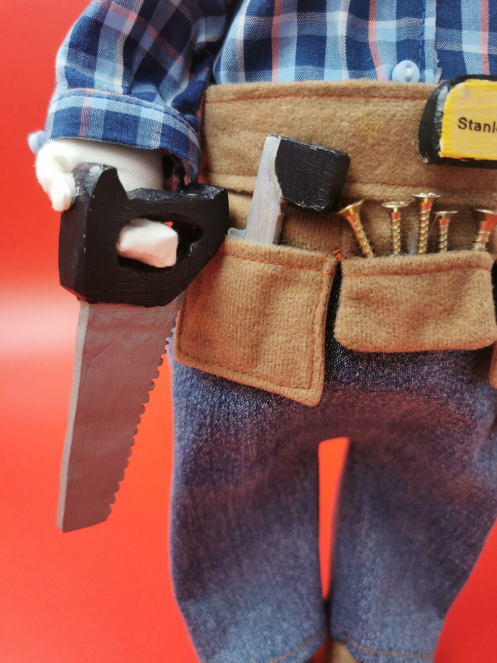 Thumbnail: The carpenter is holding a carved saw, painted black handle and silver blade.