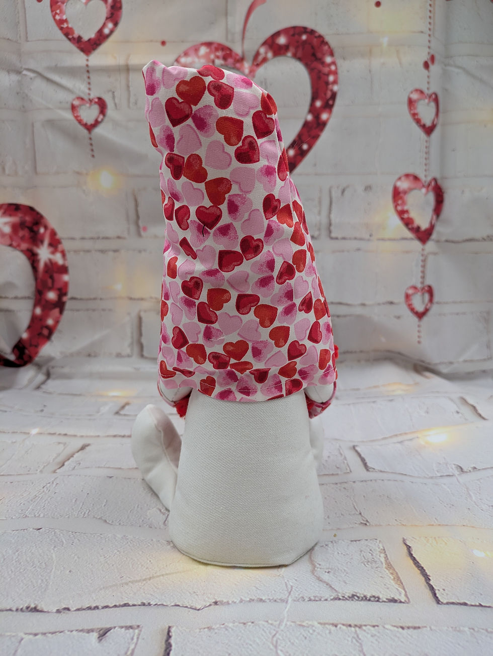 Thumbnail: White body with red heart on feet. Heart fabric hat, red plaits. Red velvet heart saying Happy Valentines.