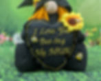 Thumbnail: Black body and hat, sunflowers with bees. Holding a heart I Love you bee-ing my mum