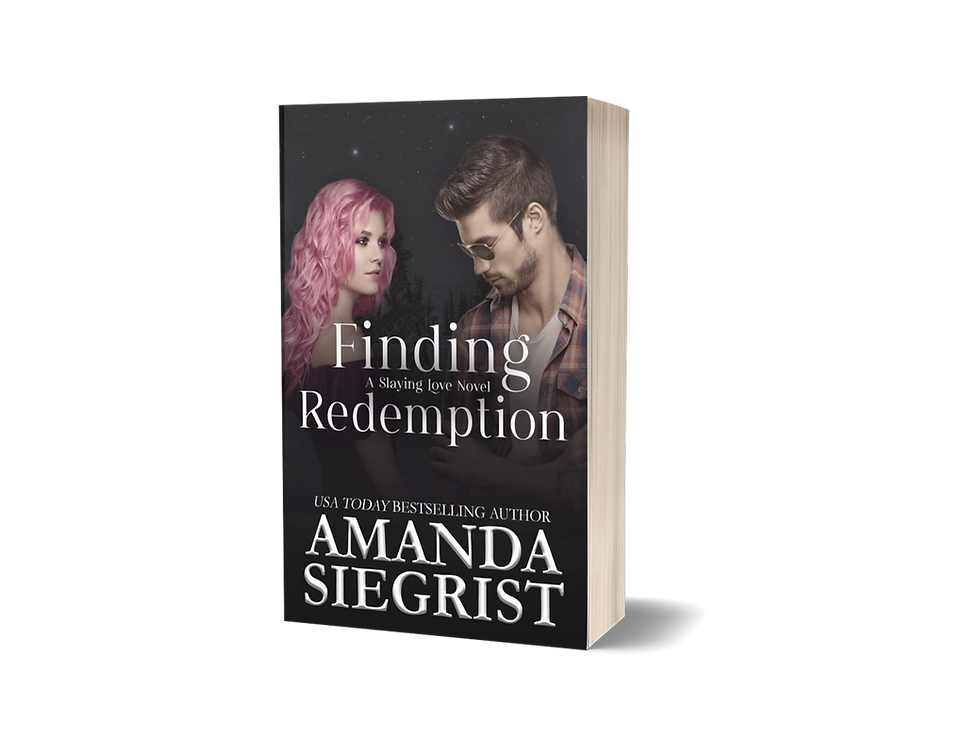 Twinkling stars in the background. A woman with pink hair is on the left with a man wearing sunglasses looking down is on the right. In the middle is the title Finding Redemption, A Slaying Love Novel. On the bottom 
is USA Today Bestselling Author Amanda Siegrist