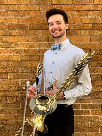 Joseph posing with two trombones