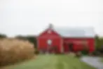 Outdoor look at Barn Swallow Farm's classic red barn reception building