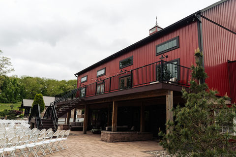 rows of wedding ceremony seats and the covered barn patio 