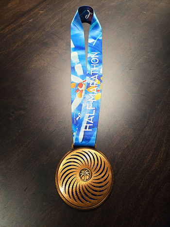 Miami marathon selected the best Miami based artist Laelanie Larach to design the ribbon medal