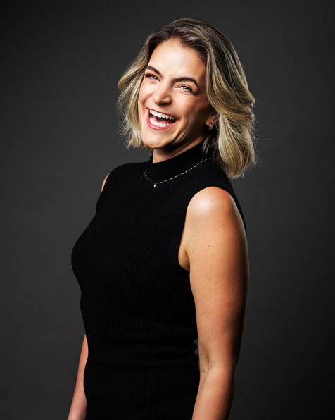 Smiling headshot of a woman in a sleeveless black top, captured by Vancouver photographer Hampus Danielsson
