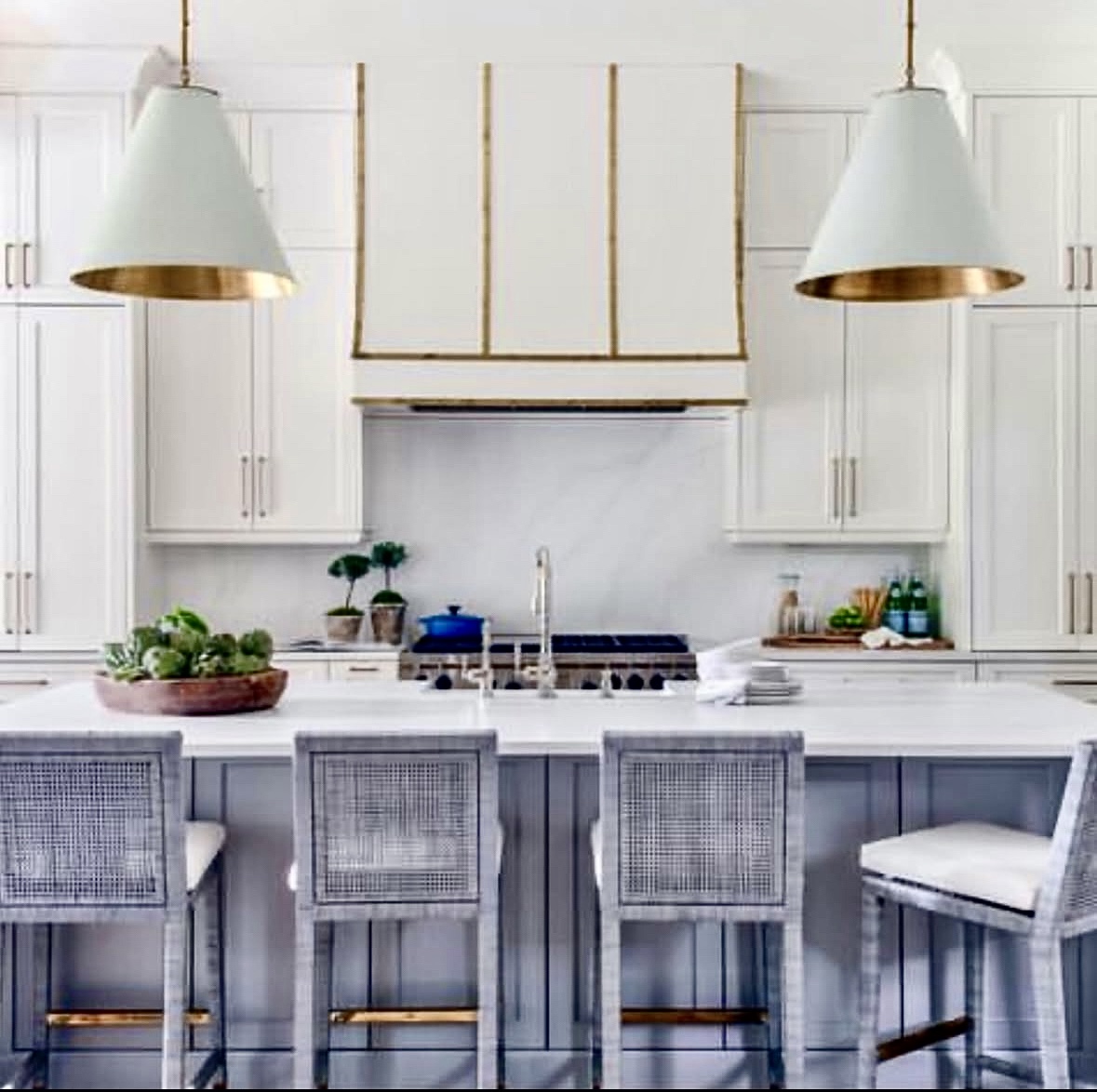 White hood with gold-toned trim and a blue kitchen island