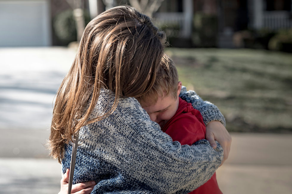 Mother hugging a child.