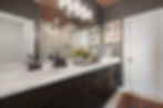 Primary bathroom with black cabinets, brown walls, and a wood ceiling for warmth and contrast.