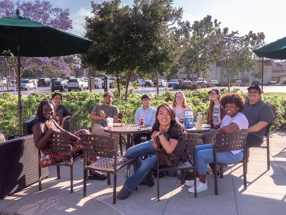 A group of seated people from different backgrounds posing for a group picture.