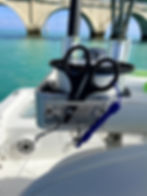 Thumbnail: Rigit scissor plate securing rigging scissors next to a spool of fishing leader line