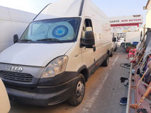 Inspecting the van's undercarriage for damage in Dubai