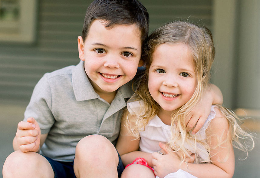 Happy young boy and girl with healthy smiles at Dentini Pediatric Dentistry in Houston, TX—where little teeth get big care in a warm, family-friendly environment.