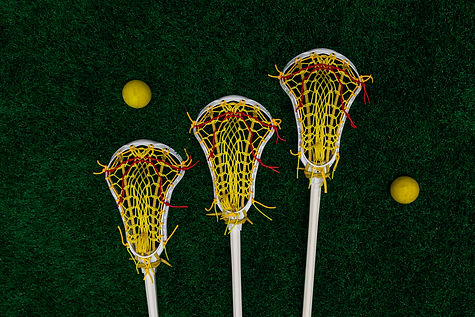 Women's lacrosse sticks and balls laying