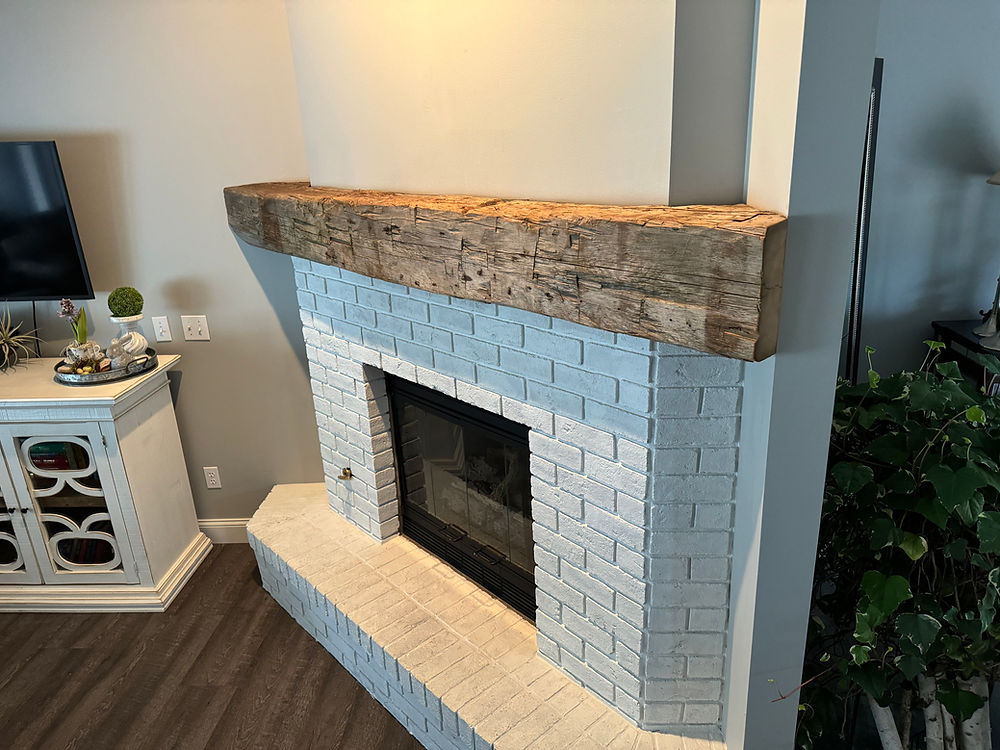 Northern Michigan reclaimed hand hewn barnwood fireplace mantel.