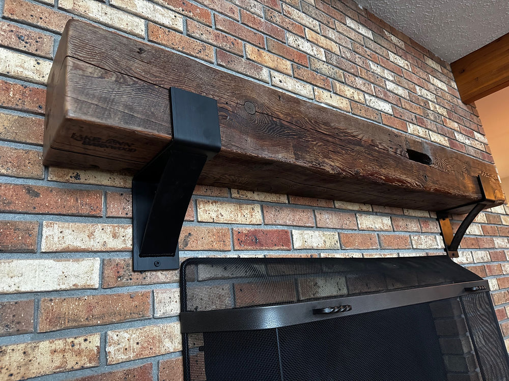 Rough sawn barnwood beam mantel with brackets and mortise