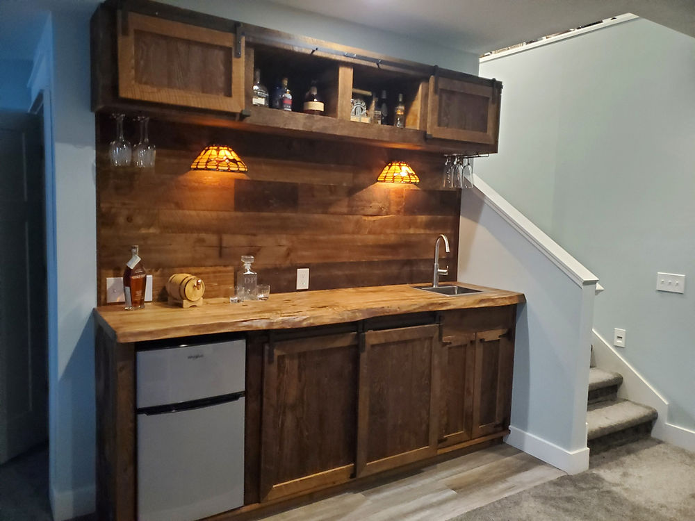 Wet bar with Northern Michigan reclaimed barnwood doors, wall cladding and slap bar top